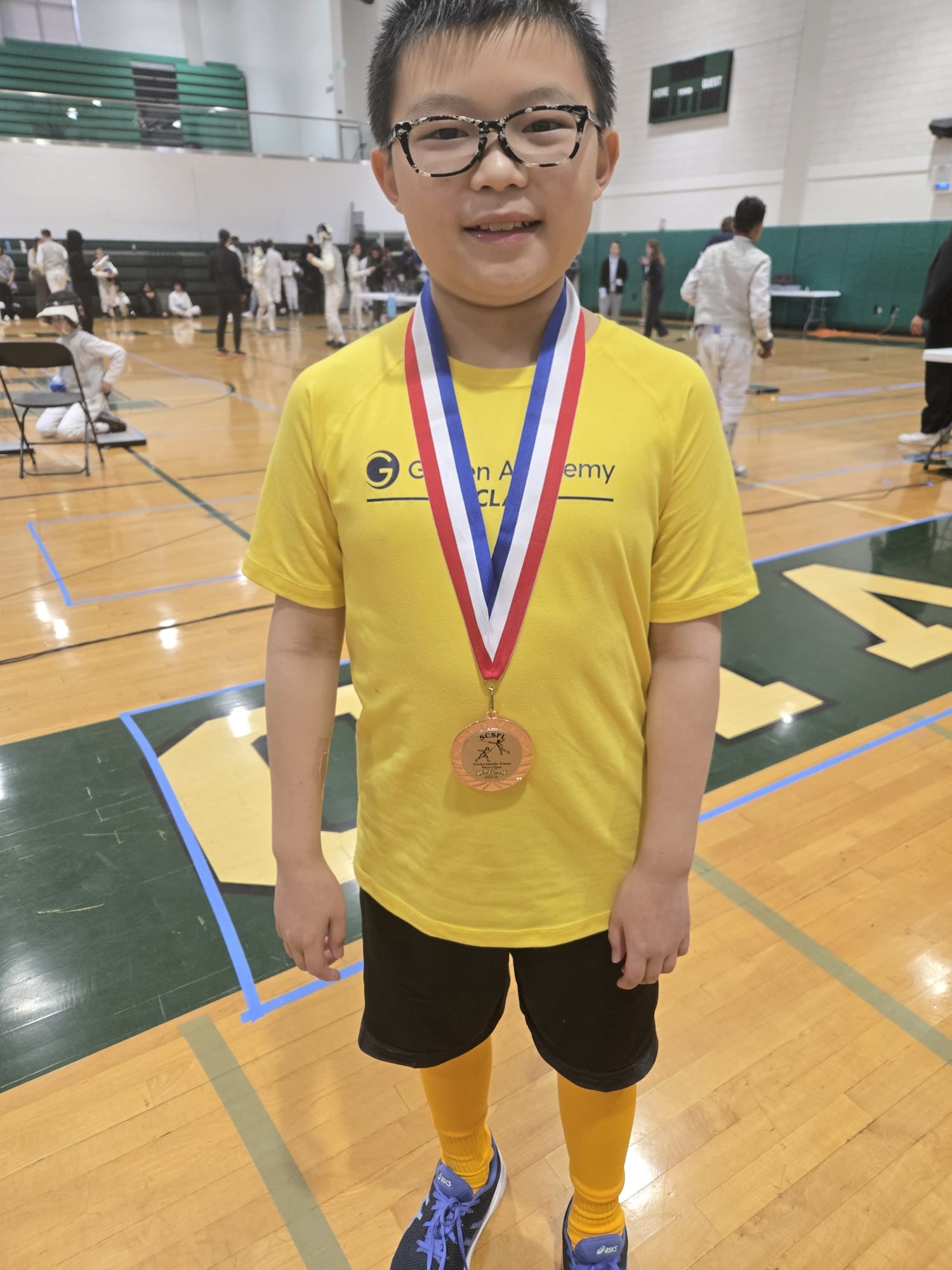 Alex Chen smiling with medal around his neck.